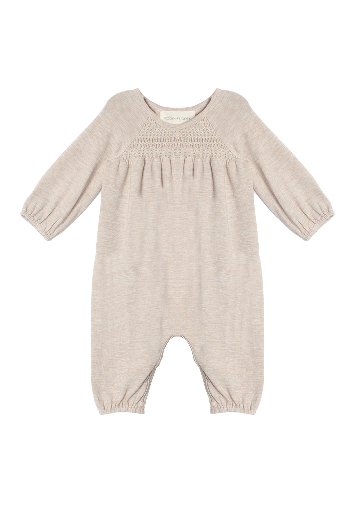 The Millie Romper by Mabel and Honey is a light beige long-sleeve one-piece with gathered elastic cuffs, a smocked pleated chest, and a classic round neckline.