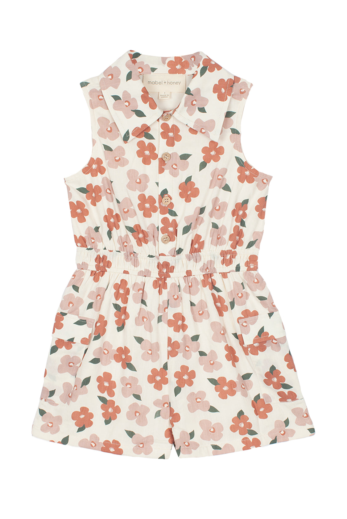 The Mavery Floral Romper by Mabel and Honey is a sleeveless, collared kids’ romper in a pink and red floral print with an elastic waistband and front buttons—perfect for sunny days.
