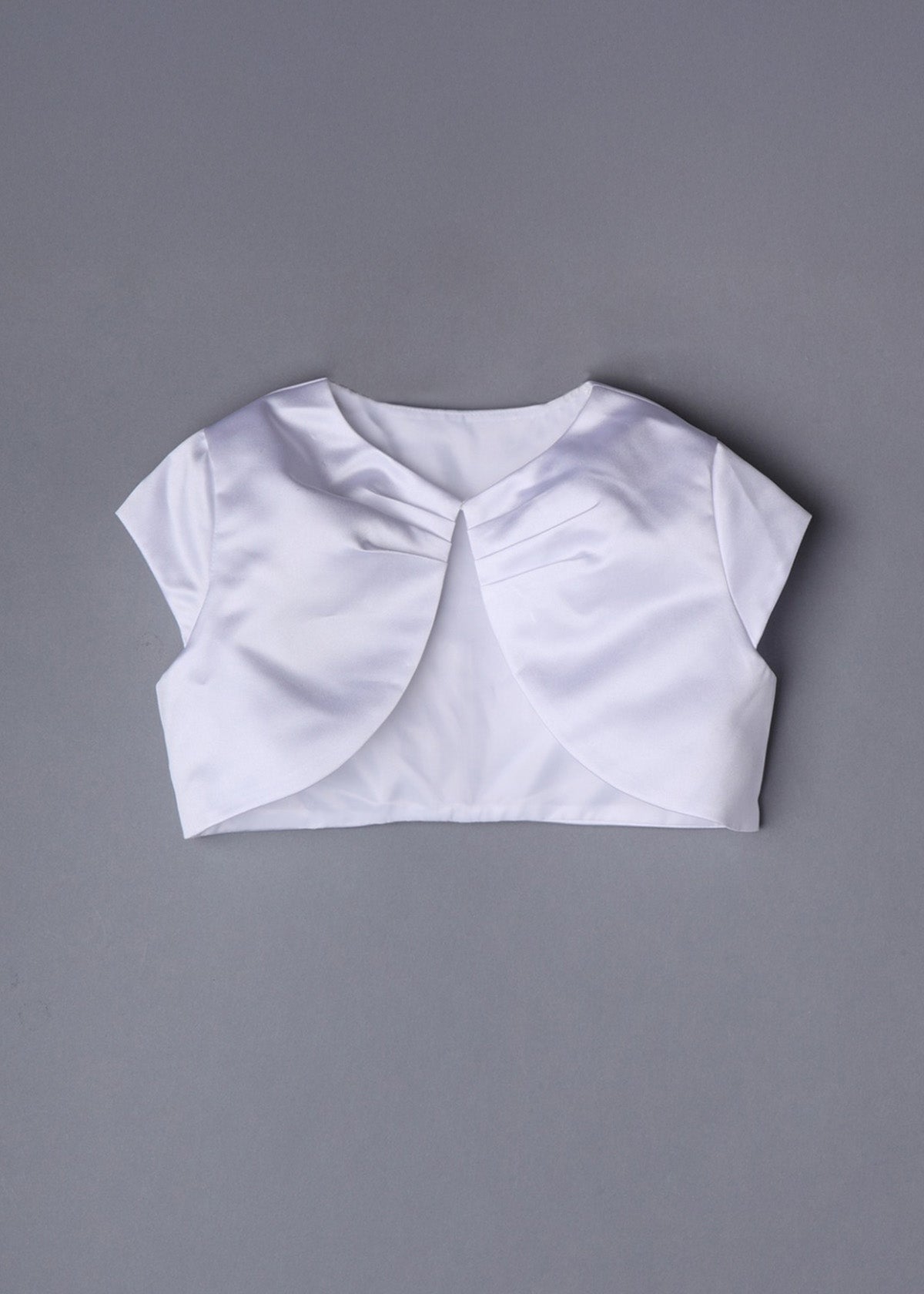The Mabel and Honey Communion Satin Bolero features white satin, short sleeves, a rounded front opening, and gentle neckline gathering—ideal for communions or special occasions—shown on a plain gray background.