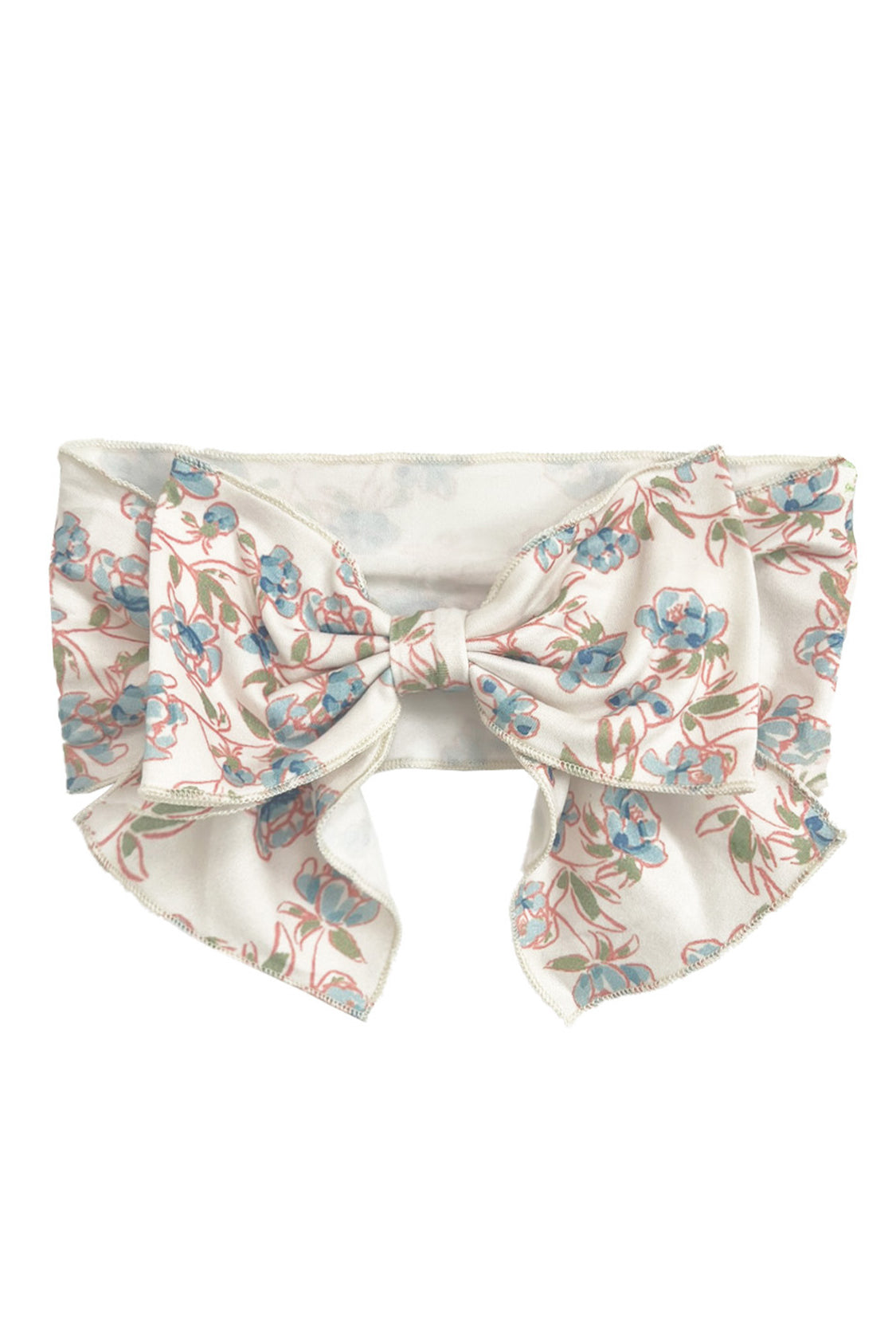 The Sadie Hair Accessory by Mabel and Honey is a wide white fabric headband with an oversized bow, decorated with a delicate blue and pink floral pattern and green stems.