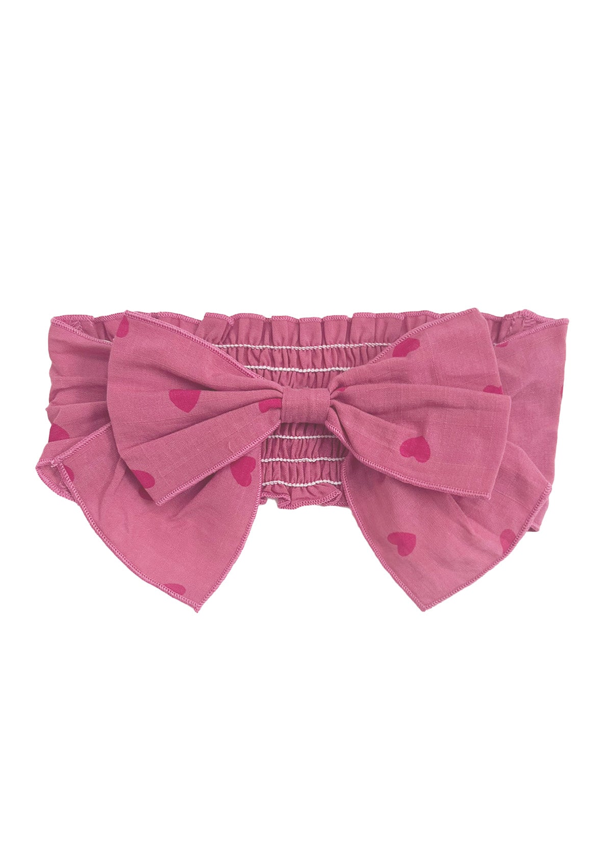 The Perfect in Pink Hair Clip Accessory by Mabel and Honey features an elastic, ruched band and a statement bow with a charming red heart pattern.