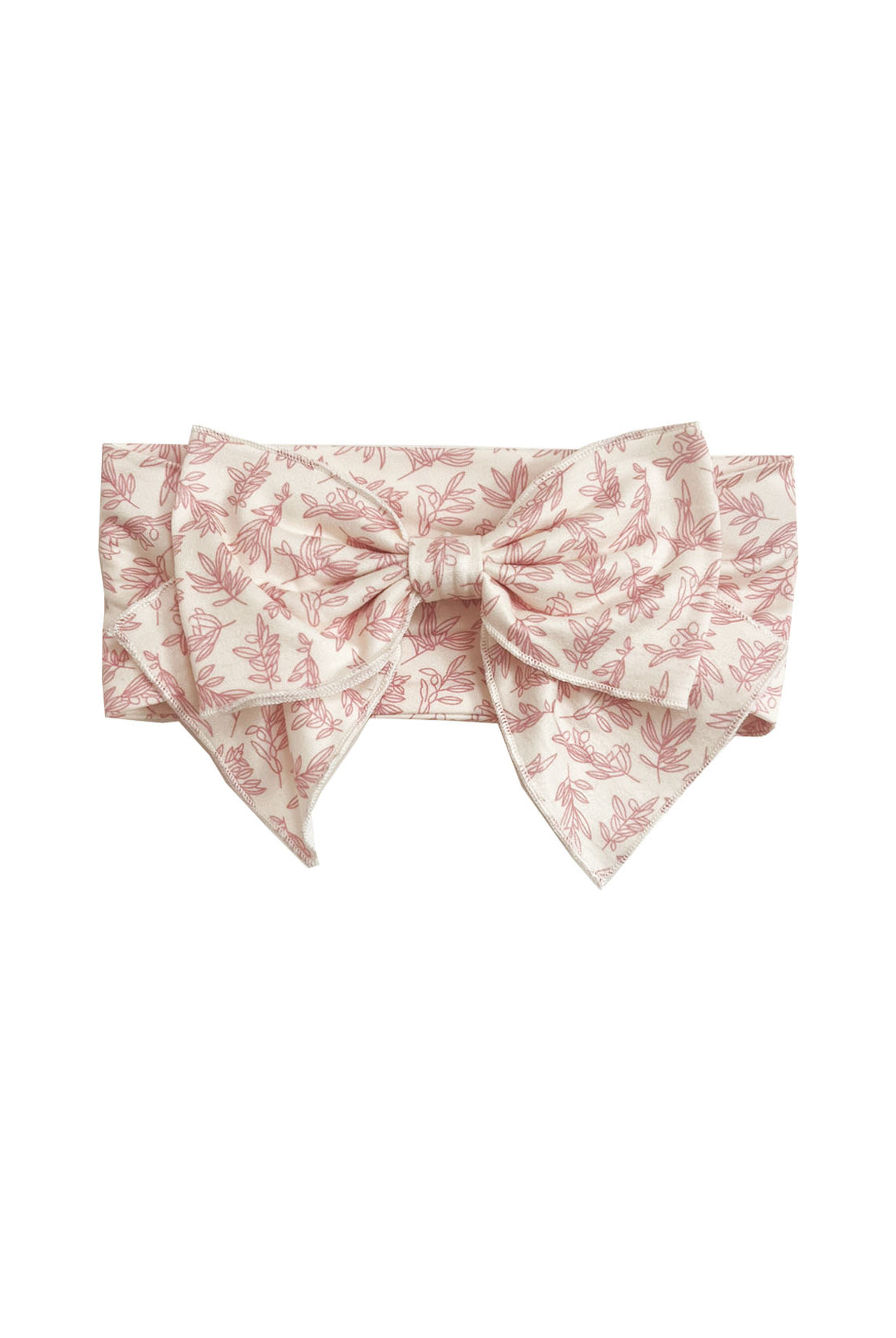 The Primrose Hair Accessory by Mabel and Honey features a wide, light pink fabric with a delicate floral print and a large, structured pink botanical bow at the front.