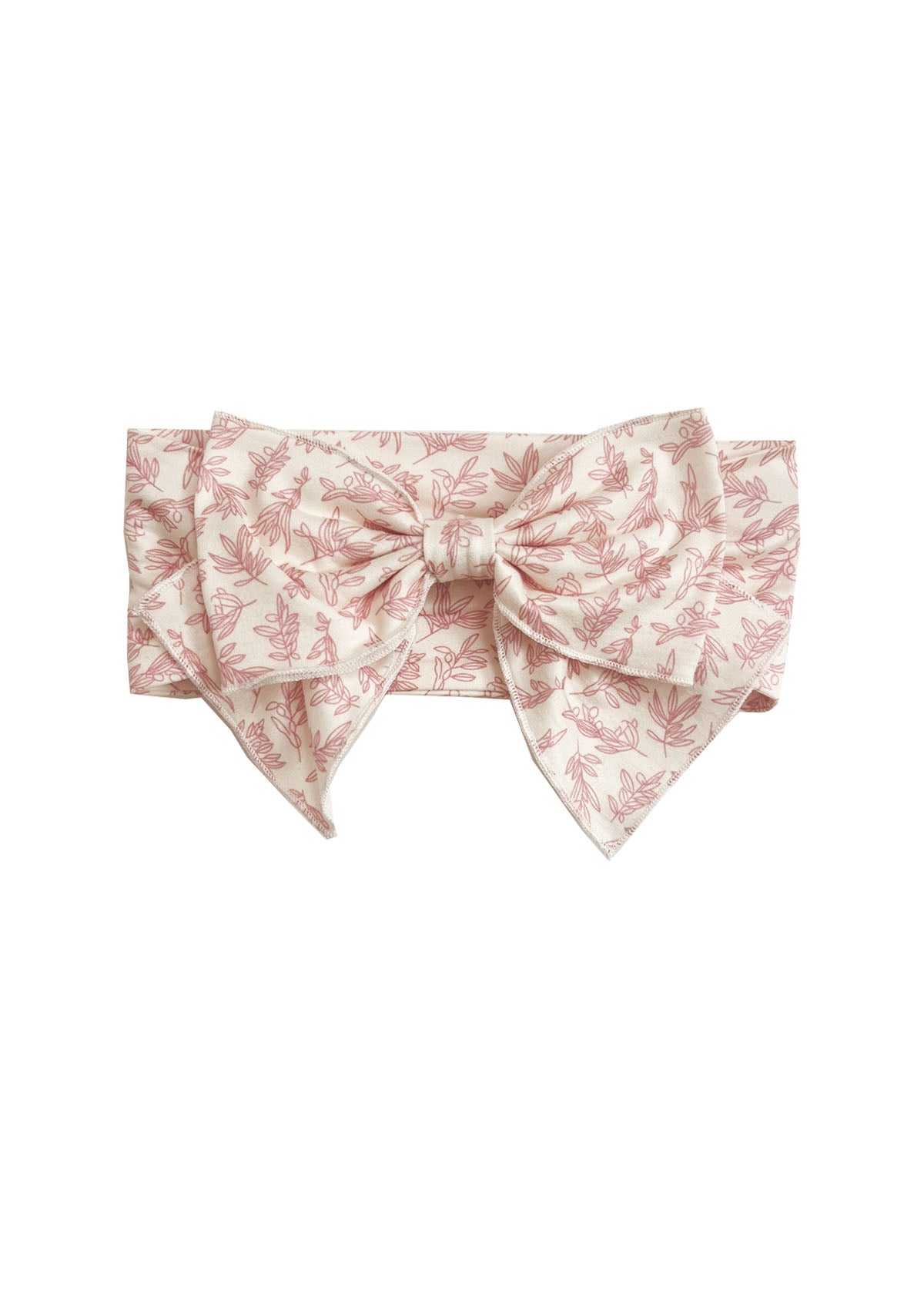 The Primrose Hair Accessory by Mabel and Honey features a wide, light pink fabric with a delicate floral print and a large, structured pink botanical bow at the front.