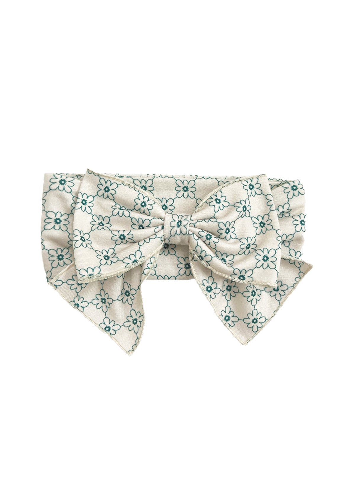 The Lillian Hair Accessory by Mabel and Honey is a vintage-inspired white fabric floral bow with teal patterns, two wide tails, a large central knot, and a textured look for added charm.