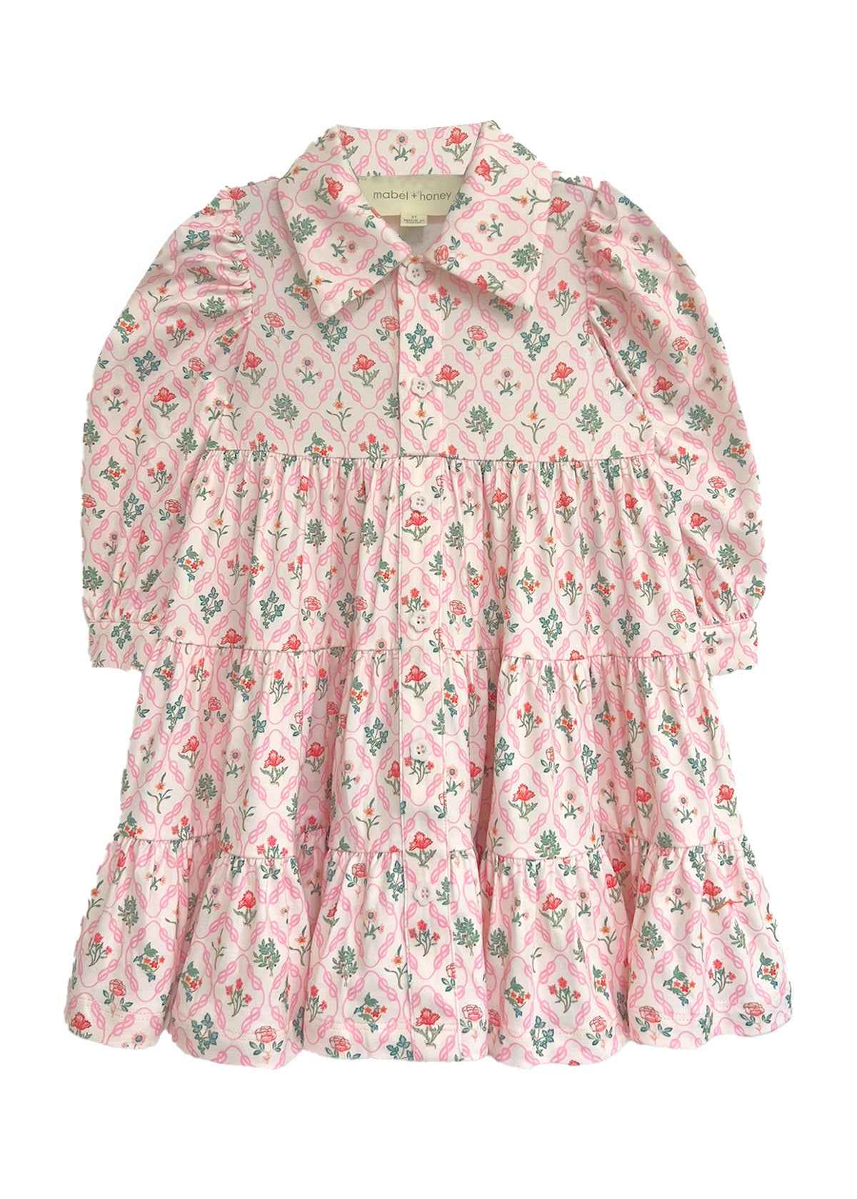 The Dixie Pink Floral Dress by Mabel and Honey is a long-sleeved dress with a tiered silhouette, pink floral pattern, a collar, and front buttons, shown flat on a white background.