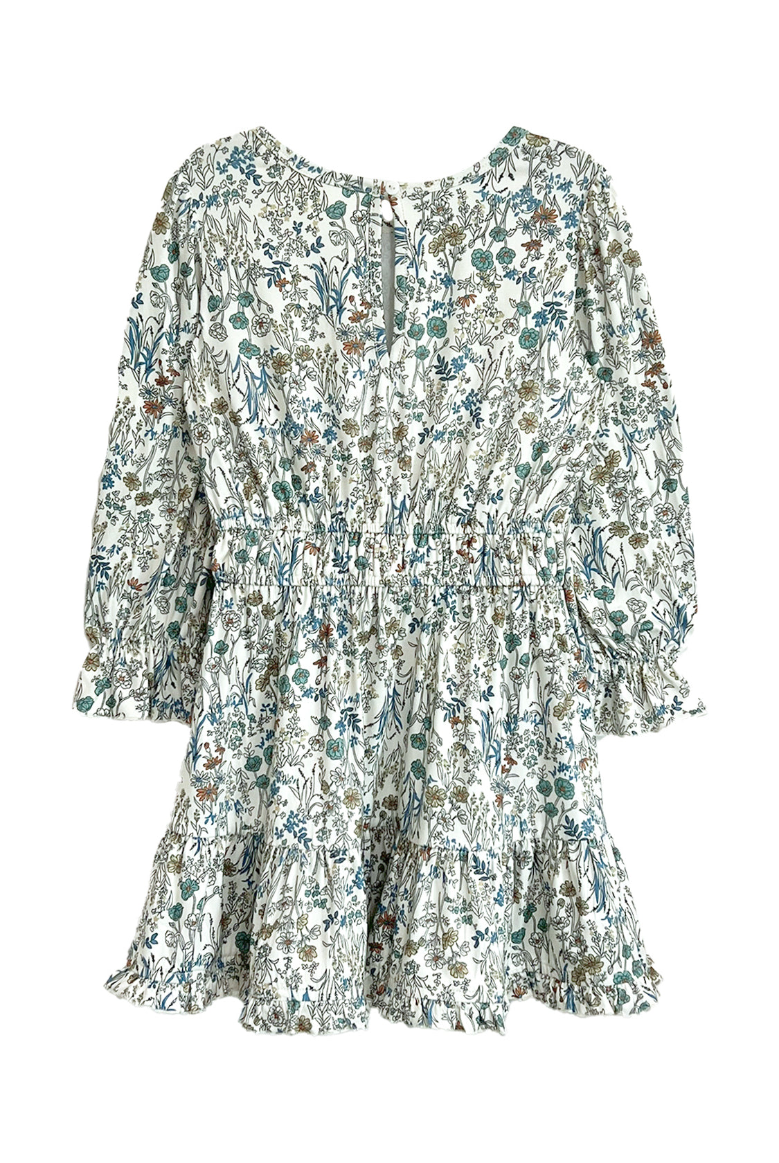 The Brooklyn Floral Dress by Mabel and Honey is a girls' knee-length dress in green, blue, and brown floral on white with long sleeves, a gathered waist, ruffled hem, and button-back closure.