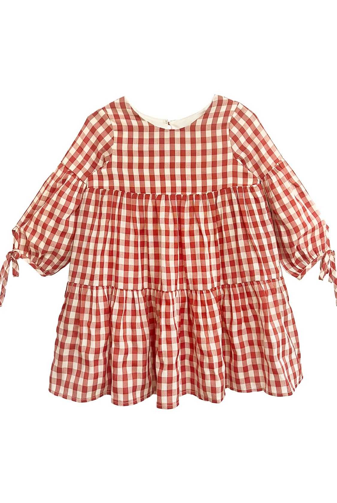 The Tis' the Season Dress by Mabel and Honey is a loose-fitting, long sleeve red and white gingham dress with tiered ruffles and cuff bow ties—ideal as a holiday dress for girls.