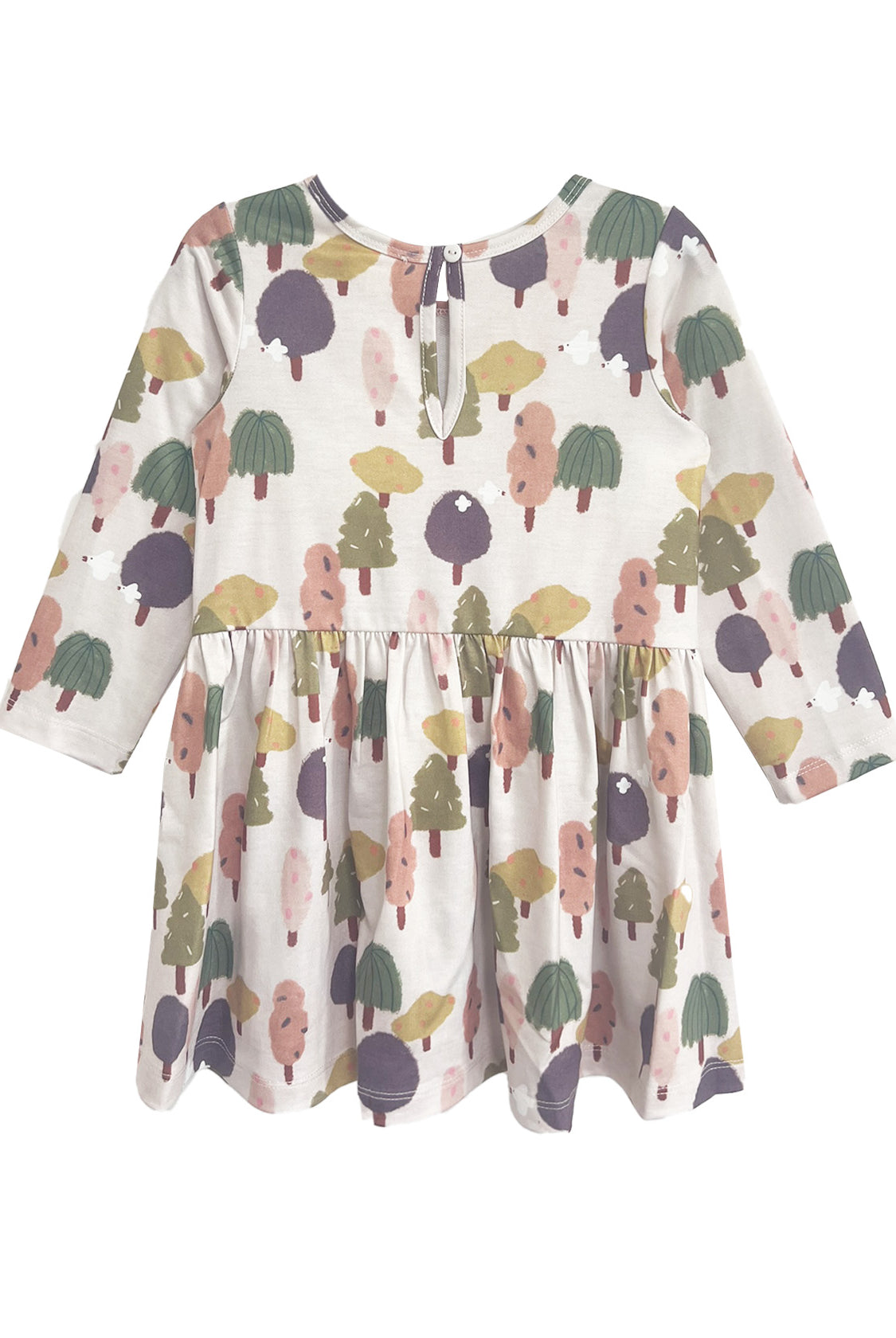 The Mabel and Honey Treehouse Dress is long-sleeved with a gathered waist, showcasing whimsical trees in muted green, purple, pink, and yellow on a light background. A keyhole button at the back adds a charming, nature-inspired touch.
