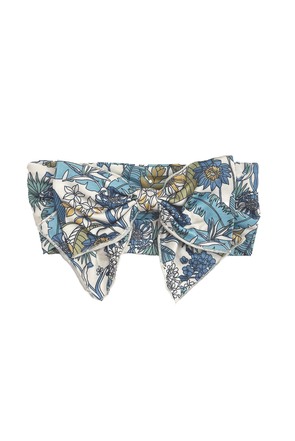 The Leah Hair Accessory by Mabel and Honey is a floral headband with a large bow, featuring a charming blue, green, and white print.