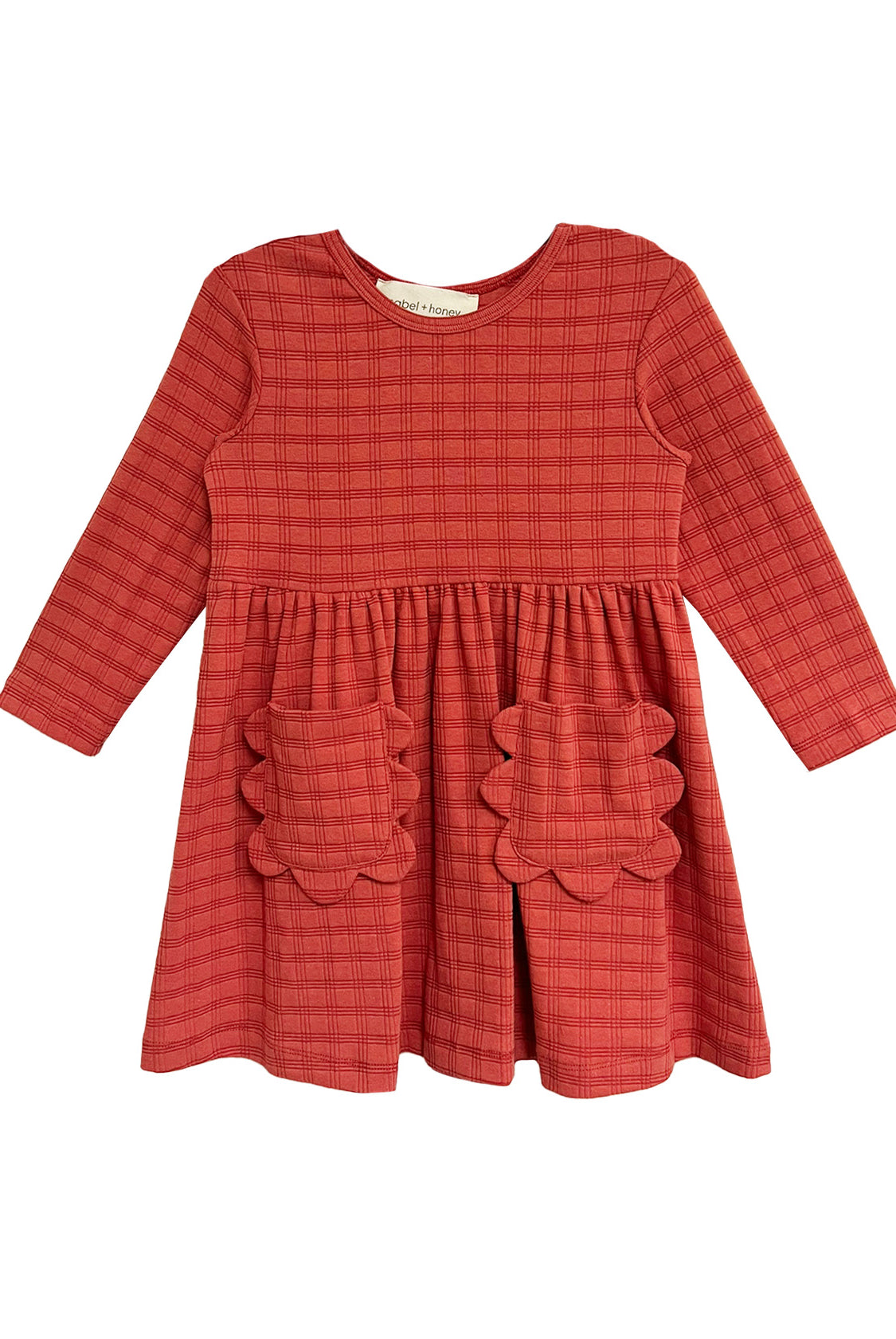 The Mabel and Honey Tea Party Red Gingham Dress features long sleeves, a round neck, gathered waist, and two scalloped skirt pockets—combining comfort and classic style for any occasion.