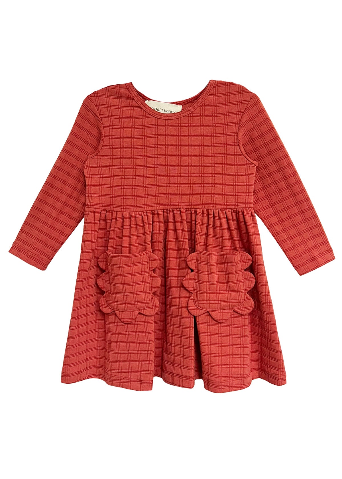 The Mabel and Honey Tea Party Red Gingham Dress features long sleeves, a round neck, gathered waist, and two scalloped skirt pockets—combining comfort and classic style for any occasion.