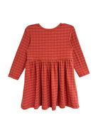 The Mabel and Honey Tea Party Red Gingham Dress is a long-sleeve, knee-length girls dress with a gathered waist and flared skirt, perfect for everyday elegance or as a charming tea party outfit, shown on a white background.