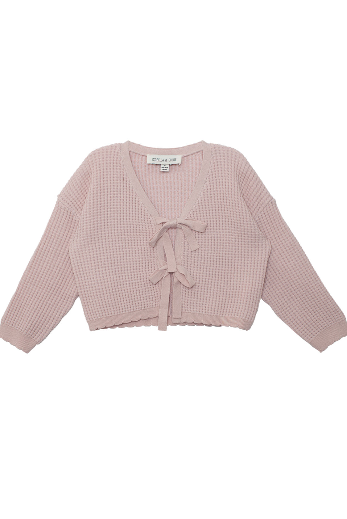The Isobella and Chloe Ballerina Sweater features a light pink, long-sleeve, cropped waffle-knit design with a V-neckline and two front tie closures. The label is visible inside the neckline.