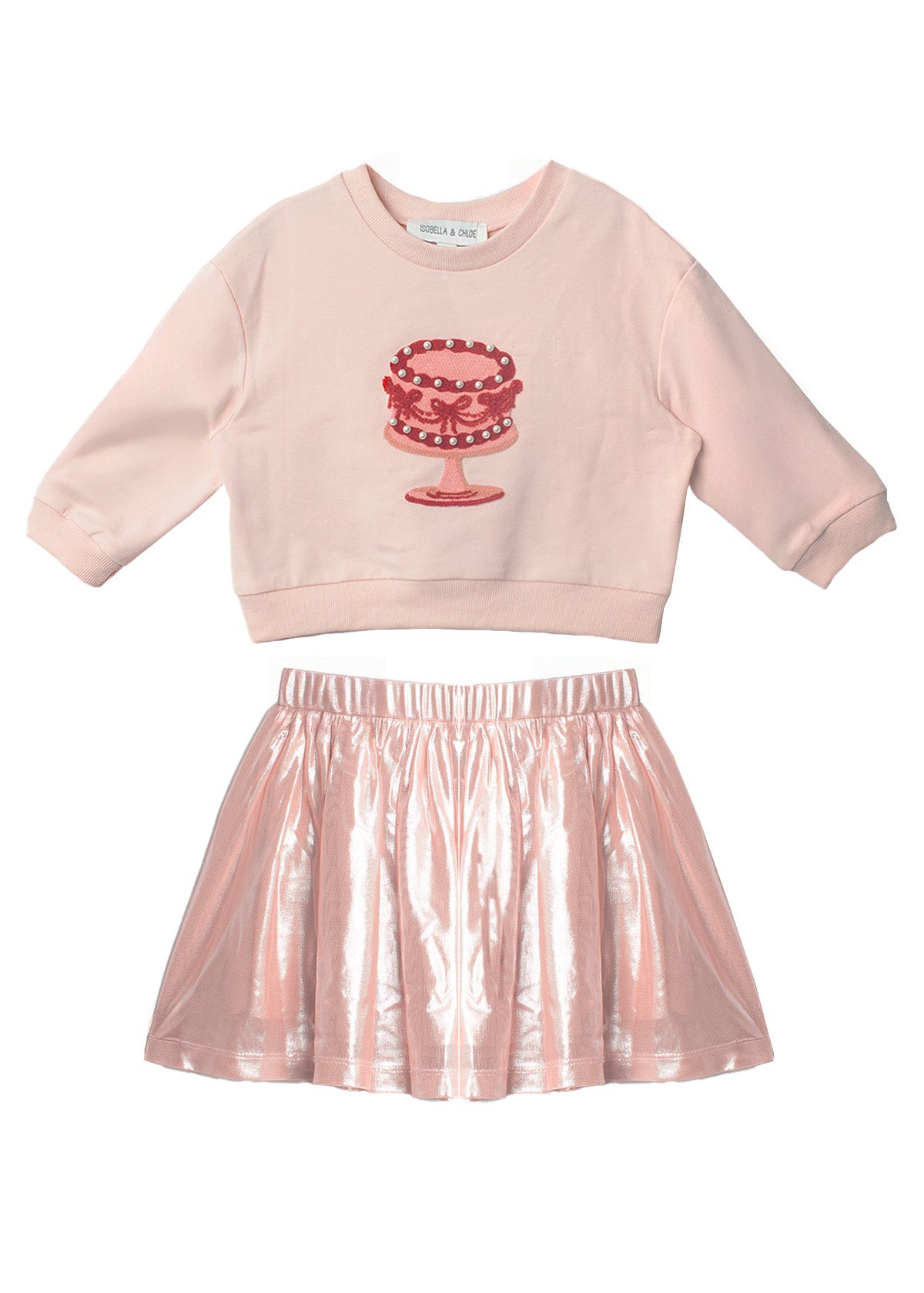 The Isobella and Chloe Sweet Cakes Two Piece Set features a light pink embroidered cake long-sleeve top and a shiny metallic pink skirt—perfect for sweet style in any girl’s wardrobe.