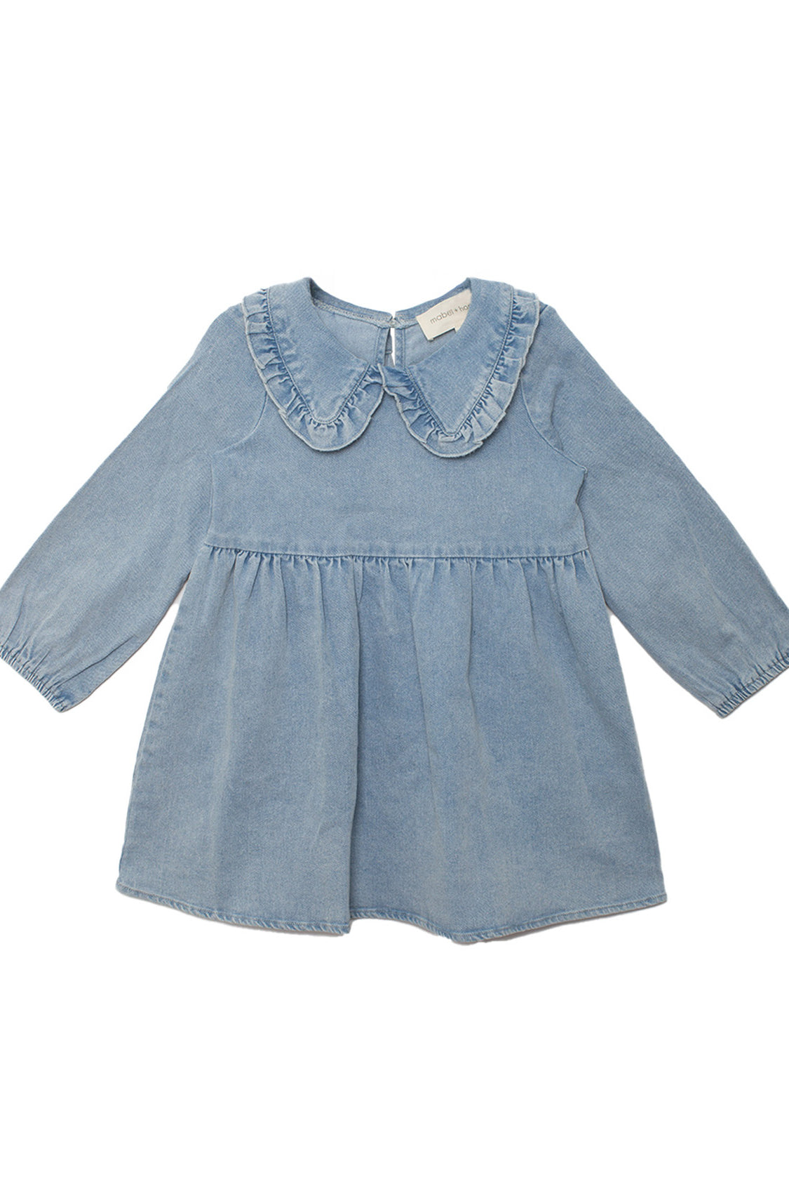 The Mabel and Honey Denim Days Long Sleeve Dress is a charming light blue denim A-line dress for kids, featuring a ruffled Peter Pan collar and gathered waist, shown on a white background.