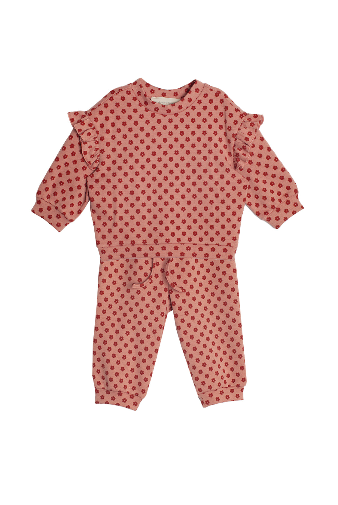 The Mabel and Honey Red Velvet Two Piece Set is a cozy pink knit toddler outfit with red polka dots, ruffled shoulders, and matching pants.