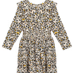 The Mabel + Honey Piper Rayon Dress is a long-sleeve girls' dress featuring a smocked waist, ruffled collar, and an all-over leopard print in black, brown, and yellow on a white background.