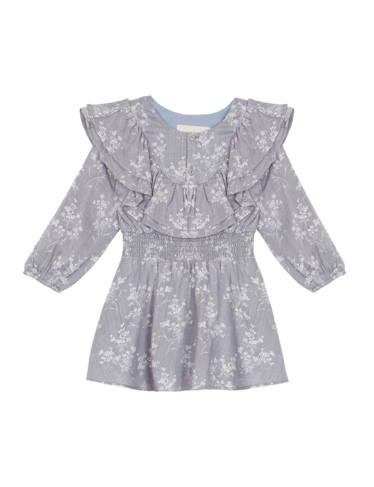 The Frost Rayon Dress by Mabel + Honey is a light purple, long-sleeve dress for little girls featuring a white wildflower print, ruffled shoulders, and a smocked waist. With its round neckline and flowy skirt, this dress is perfect for any special occasion.