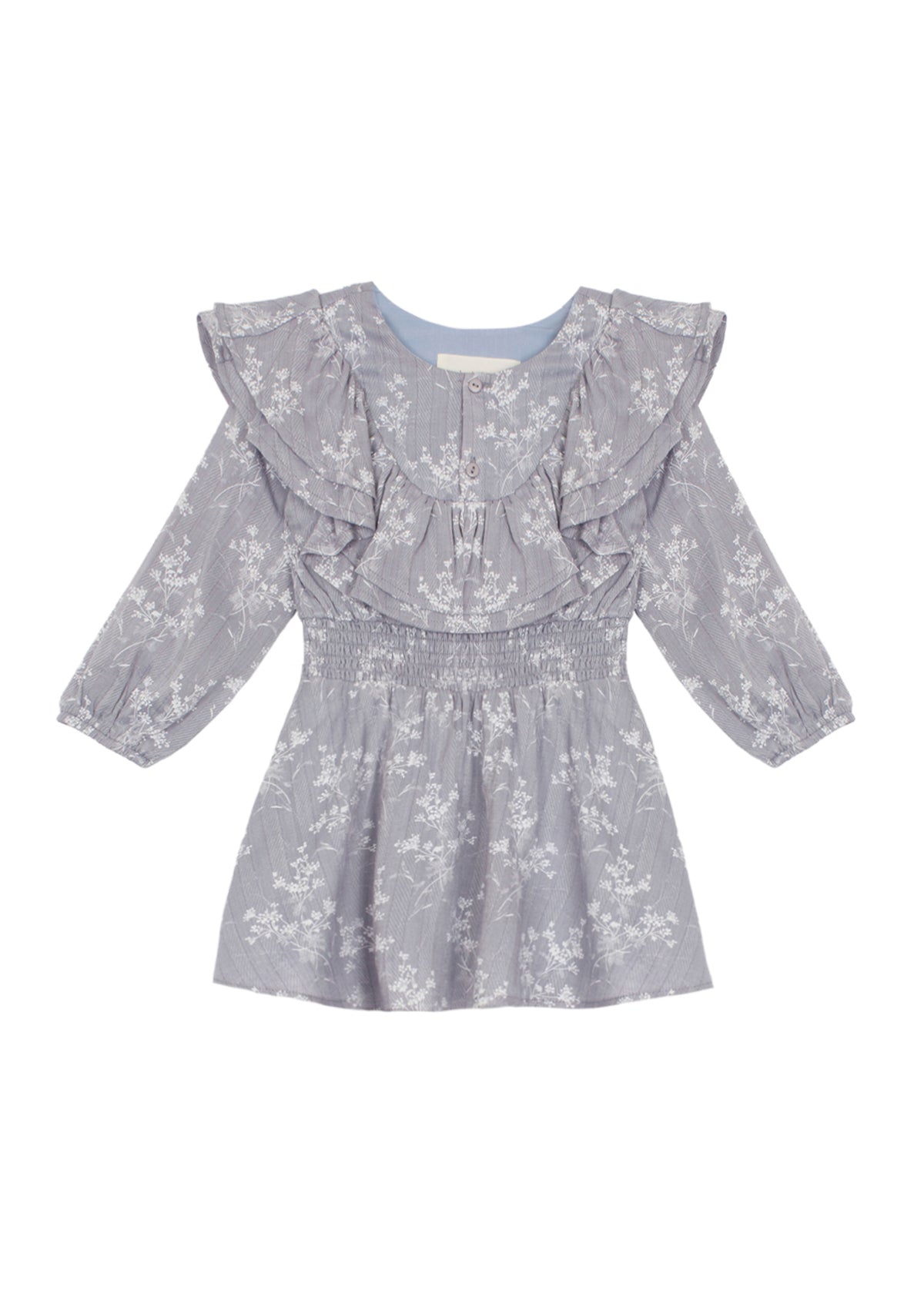 The Frost Rayon Dress by Mabel + Honey is a light purple, long-sleeve dress for little girls featuring a white wildflower print, ruffled shoulders, and a smocked waist. With its round neckline and flowy skirt, this dress is perfect for any special occasion.