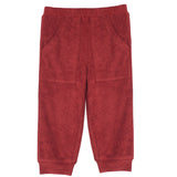 A pair of Clay Terry Cloth Bottom Relaxed Jogger Pants with pockets by Mabel + Honey, featuring a cozy red fleece material, elastic waistband, two front pockets, and cuffed ankle hems, showcased against a plain white background. These stylish girls' jogger pants provide comfort and versatility for everyday wear.