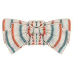 The Hermosa Headband by Mabel and Honey features orange, teal, and white stripes on textured cotton, tied in a neat bow—perfect as a charming hair accessory for your baby.