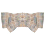 The Flower Farm Gingham Headband by Mabel and Honey features a pastel plaid design with a decorative bow, wide ruffled sides, and a stretchy, shirred back for comfort.