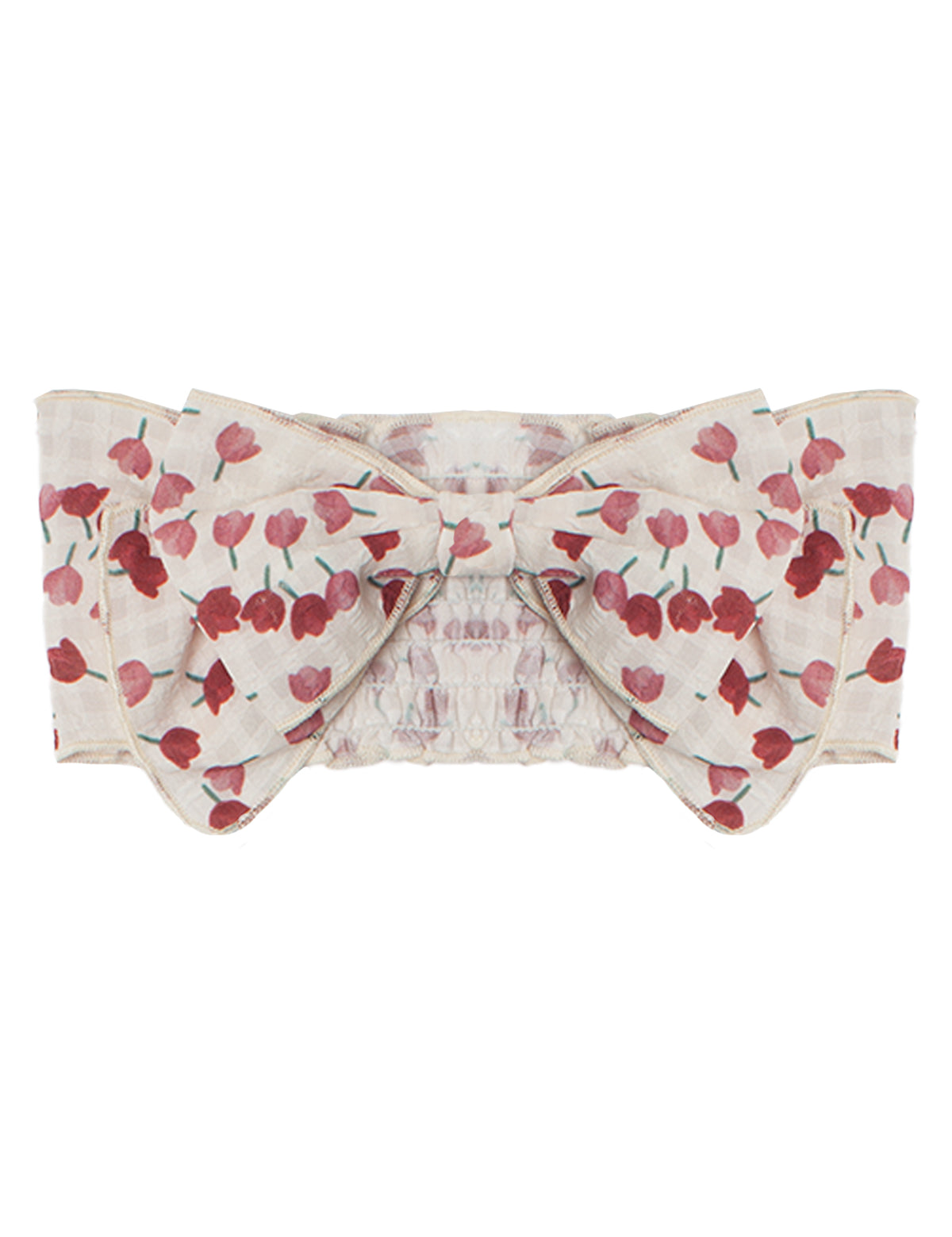The Tulip Fields Headband by Mabel and Honey features a wide, cream cotton band with a red floral pattern, a large center bow, and an elastic back. The fabric is slightly textured and 100% cotton.