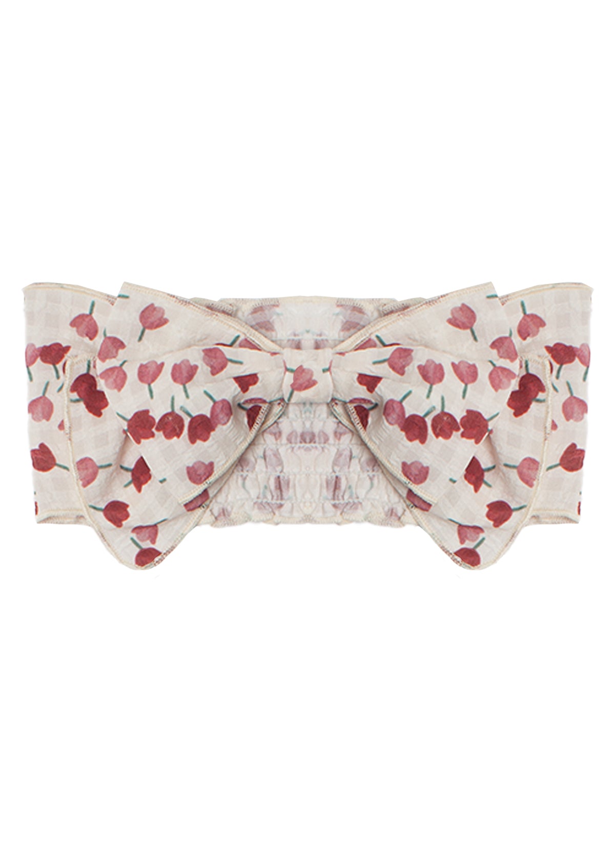 The Tulip Fields Headband by Mabel and Honey features a wide, cream cotton band with a red floral pattern, a large center bow, and an elastic back. The fabric is slightly textured and 100% cotton.