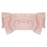 The Wildflower Headband by Mabel and Honey is a light pink fabric baby accessory with a white leopard print and gathered center detailing.