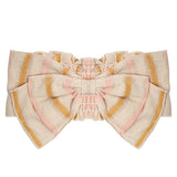 The Madeline Headband by Mabel and Honey is a large cotton bow with beige, pink, and yellow stripes in a symmetrical, slightly ruffled design—perfect for your baby’s adorable style.