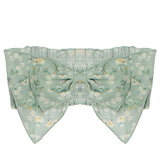 The Garden Party Green Headband by Mabel and Honey features a mint green cotton band with a large bow, adorned with white and yellow floral patterns, scalloped edges, and is perfect for babies or as a charming hair accessory.