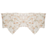 The Madeline Brown Headband by Mabel and Honey is a sheer white cotton baby hair accessory, featuring a floral pattern with light orange flowers, green leaves, and a large decorative bow in the center.