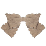 The Madeline Hair Clip Brown by Mabel and Honey is a large, textured beige bow with ruffled, scalloped edges, crafted from soft cotton knit—perfect for babies and photographed on a white background.