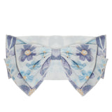 The Mabel and Honey Flower Farm Floral Headband features a soft blue and lavender floral pattern with yellow accents on a white background.