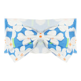 The Aloha Headband by Mabel and Honey is a 100% cotton fabric baby hair accessory with a large bow, showcasing a blue background and white floral pattern accented with orange and green.