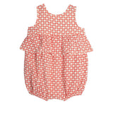 The Little Red Wagon Baby Romper by Mabel and Honey is a sleeveless cotton romper with a ruffle waist, white background, red and white geometric square pattern, and elasticated leg openings—perfect for style and comfort.