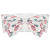 The Freshly Picked Headband by Mabel and Honey features a white cotton design with a large center bow, adorned with pink and teal floral prints and green leaves.