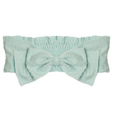 The Mabel and Honey Creamsicle Pink Headband is made from 100% cotton with a large center bow and ruched elastic back—an adorable hair accessory for babies.