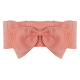 The Butterfly Kisses Headband by Mabel and Honey is a peach-toned, structured bow headband crafted from 100% cotton sheer, textured fabric.