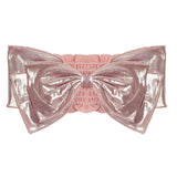 The Shine Bright Headband Yellow by Mabel and Honey is a shiny yellow metallic headband with an oversized double-layer bow and ruched elastic center, doubling as a playful statement hair accessory for babies.