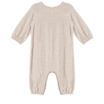 The Millie Romper by Mabel and Honey is a beige long-sleeve piece with an empire waist, elastic cuffs at the sleeves and ankles, smock detailing, and soft textured fabric, shown laid flat on a white background.