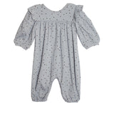 The Twinkle Twinkle Romper by Mabel and Honey features a blue-gray design with long puffed sleeves, elastic cuffs, ruffled shoulders, and a soft, lightweight fabric adorned with small black dots.