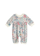 The Melody Romper by Mabel and Honey is a long-sleeve baby romper with a colorful floral pattern, cream collar and cuffs, shown on a white background.