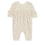 The Mabel and Honey “Breakfast in Bed Romper” is a cream-colored long-sleeve baby girls romper with ruffled sleeves, chest and cuff accents, and a delicate green floral pattern. Displayed flat on a white background.