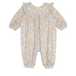 The Darling Orchard Romper by Mabel and Honey is a long-sleeve cotton baby romper with a ruffled collar and cuffs, showcasing a blue, orange, and yellow floral print on white.