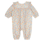 The Darling Orchard Romper by Mabel and Honey is a soft cotton, long-sleeved floral romper with ruffled shoulders and a pastel orange, blue, and yellow print on a light background—perfect for comfy, charming style for your baby.