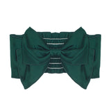 The Mabel and Honey Mistletoe Hair Accessory features a wide emerald green band with a large satin bow in the center and decorative horizontal light stitching for a festive touch.