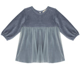 The Mabel and Honey Skylar Blue Suede Dress features long sleeves, a suede bodice, and a sheer, flowy tulle skirt in soft slate blue.