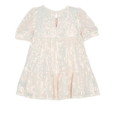 The Taylor Sequined Toddler Dress by Isobella and Chloe is a light pink, short-sleeved dress with a tiered skirt, shiny sequin accents, and a back keyhole closure—ideal for special occasions.