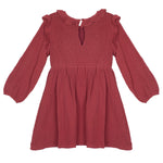 The Autumn Dress Red by Mabel and Honey is a long-sleeve, knee-length girls’ dress in deep rose gauze with a ruched bodice, ruffled collar and shoulders, keyhole button, and a loose, gathered skirt and sleeves.